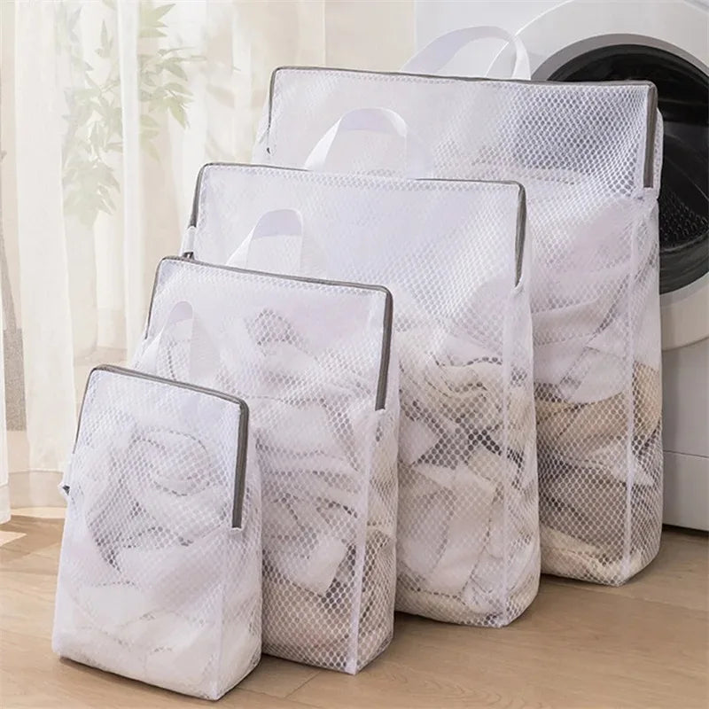 Set of mesh laundry bags in front of a washing machine