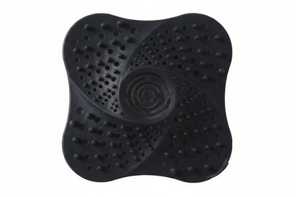 Black, white, and blue silicone drain cover on a white background